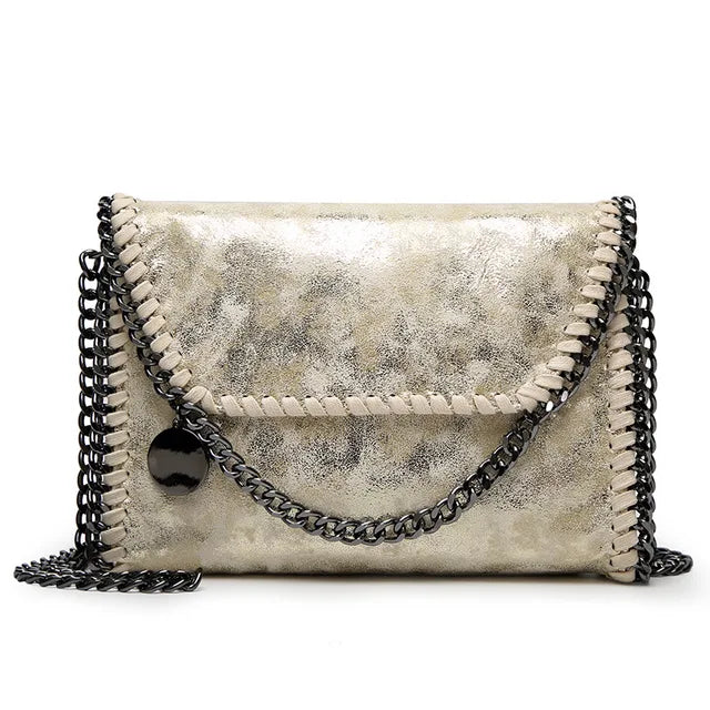 Suede clutch with chain embellishment